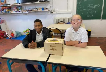 élève à coté d'une urne